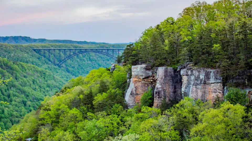 3,030 foot steel-arch, pedestrian bridge 851 feet above a river and dense green trees